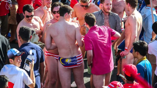 Nine Australian revellers at Malaysia's Formula 1 racing circuit have been jailed after stripping down to reveal underpants themed on Malaysia's national flag. 