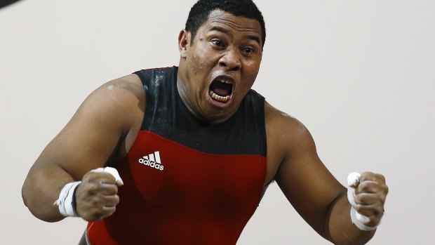 Steven Kari of Papua New Guinea celebrates after lifting 200kg to win gold.