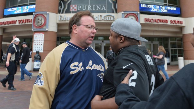 A St Louis fan and a protester get into a minor scuffle related to protests in downtown St Louis outside the Rams game at Edward Jones Dome.