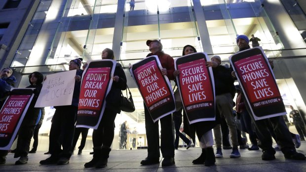 Demonstrators in Boston protest the FBI attempts to require Apple to make it easier to unlock an encrypted iPhone.