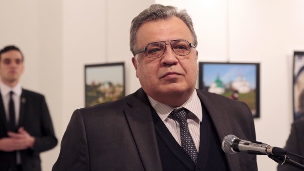 Russian Ambassador to Turkey Andrei Karlov makes an address at the gallery moments before he is shot by Mevlut Mert Altintas, seen in the background.