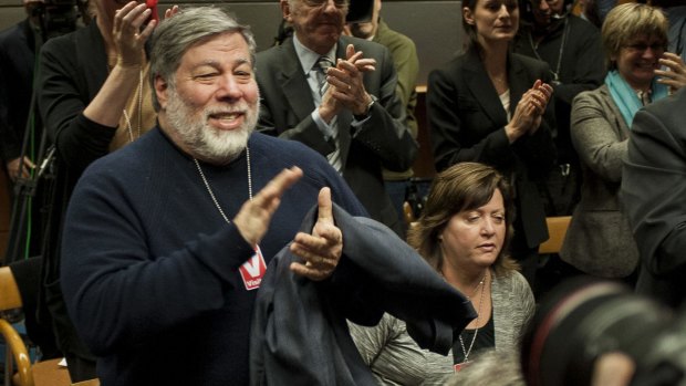 Steve Wozniak, co-founder of Apple, applauds during the meeting to vote on internet regulations at the Federal Communications Commission headquarters in Washington. 