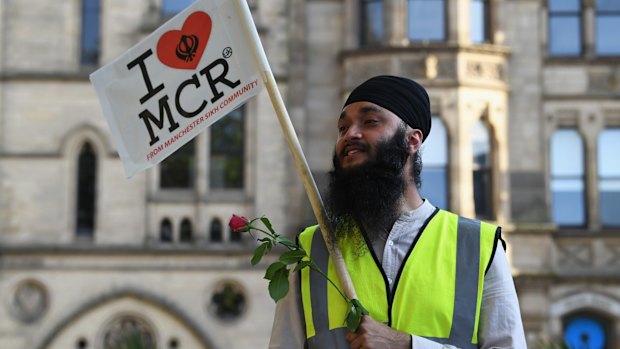 Members of the public attend a candlelit vigil, to honour the victims of the terror attack in at Albert Square in Manchester, England.