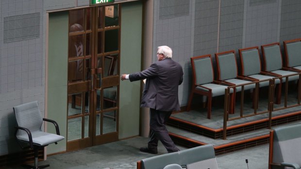 Clive Palmer leaves the chamber after his valedictory speech. 