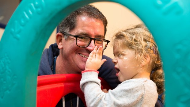 Jonathon Smith gets with the playgroup program alongside his daughter, Silver.