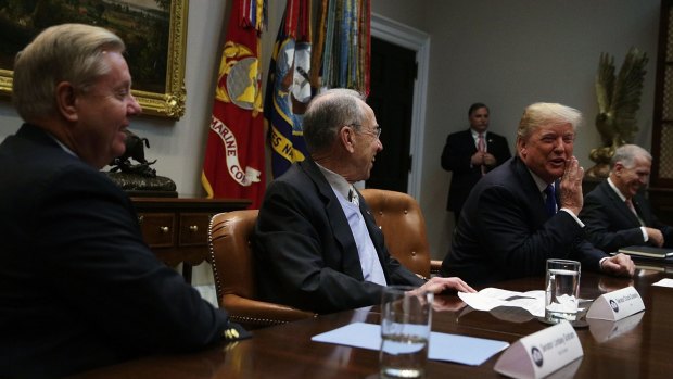 Donald Trump, right, speaks as Chuck Grassley, centre, and Lindsey Graham, left, listen during a meeting in the Roosevelt Room of the White House.