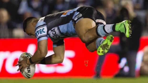 Doing it in style: Valentine Holmes scores an acrobatic try.