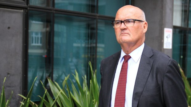 Brisbane Grammar School sporting director and former senior resident housemaster Ronald Cochrane leaves the Brisbane Magistrates court.