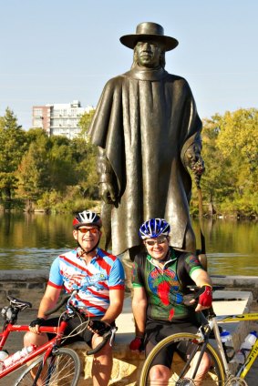 Cyclists rest beneath a sculpture of  famed blues guitarist Stevie Ray Vaughan.