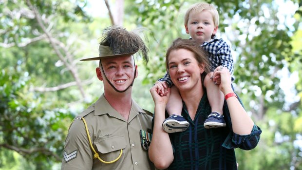 Australian Serviceman Corporal Tim McAllister of the 2/14 Light Horse Regiment with wife Olivia and two-year-old son Hamish after the Welcome Home Parade on Saturday morning.