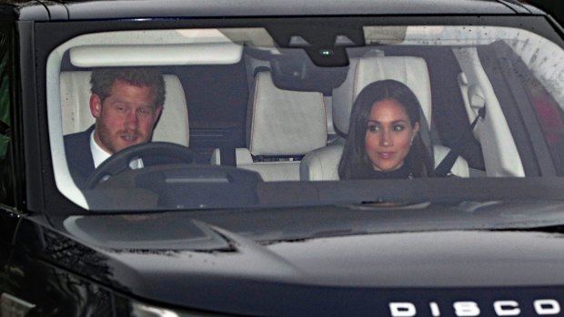 Prince Harry and Meghan Markle drive through the gates of Buckingham Palace for the Queen's traditional family Christmas lunch on Wednesday.