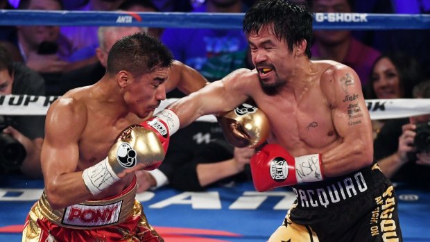 Fight night: Jessie Vargas and Manny Pacquiao battle in the third round.