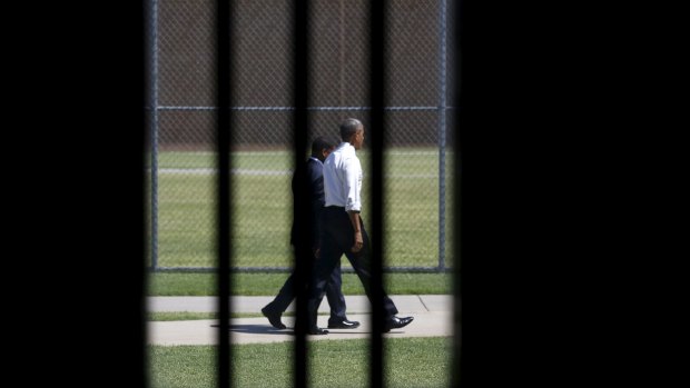 Photographed through a prison cell window, US President Barack Obama tours the El Reno Federal Correctional Institution, Oklahoma.