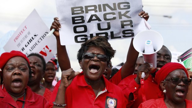Women attend a demonstration calling on the government to rescue the kidnapped girls.