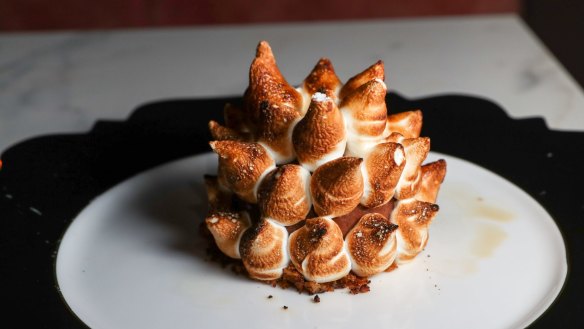 Bombe Alaska, with burnished meringue and a core of chocolate and mandarin.