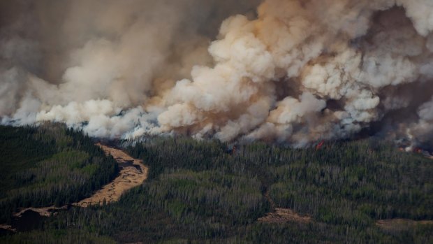 Smoke rises from Canadian wildfires burning near Fort McMurray, Alberta as the fire season started a month early this year.