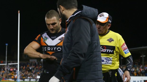Broken: Robbie Farah leaves the field with an injured hand against Penrith.