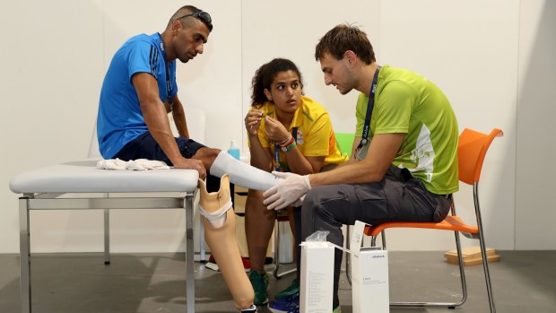 Paralympian Ibrahim Al Hussein receives a consultation with prosthetist Julian Napp at the Ottobock Techincal Repair Service Center in the Paralympic Village.
