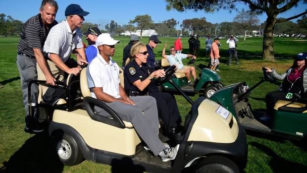 Woods leaves the course after withdrawing from the Farmers Insurance Open.
