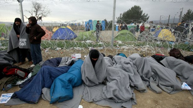 Refugees and migrants who entered Macedonia illegally and were detained by police wait to be returned to Greece at a checkpoint near Gevgelija, Macedonia.