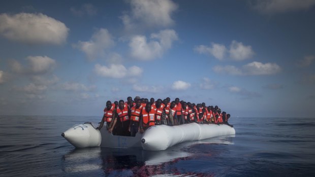 A boat carrying around 150 migrants from sub-Saharan Africa wait to be rescued north of Libya last week.