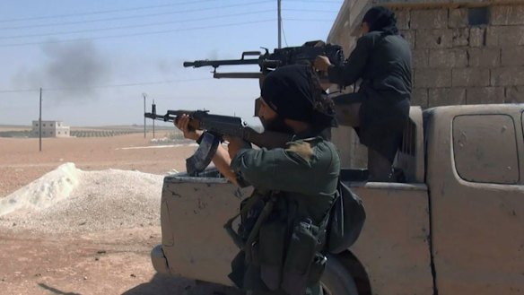 This undated image posted by supporters of Islamic State claim to show IS fighters clashing with US-backed Kurdish militias in Manbij.