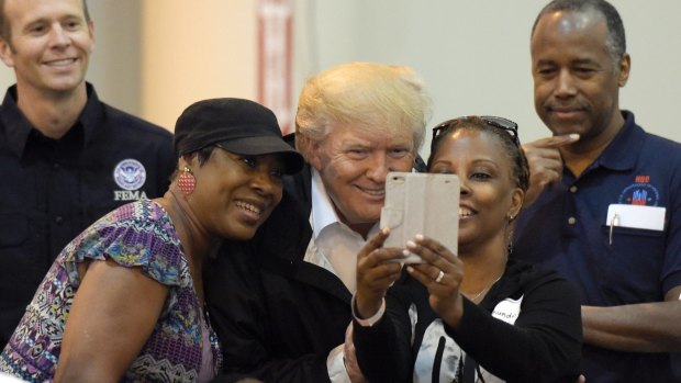 President Donald Trump  meets people affected by Hurricane Harvey during a visit to the NRG Center in Houston on Saturday.
