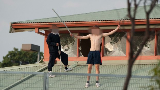 Youths protesting on the roof of the Melbourne Youth Justice Centre at Parkville in March.