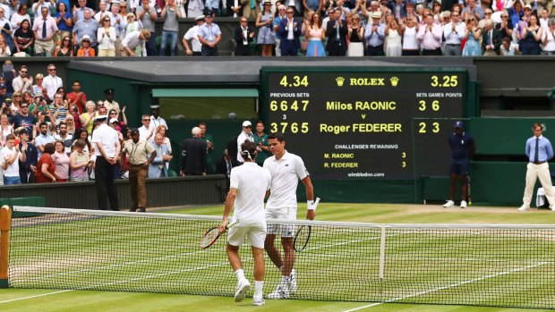 Federer congratulates Raonic.