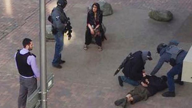 A person, on ground, being detained by police at Elizabeth Fry apartments in Barking, east London, which officers raided Sunday June 4, 2017, following Saturday's terror attack at London Bridge and Borough Market. Several people were killed in the terror attack at the heart of London and dozens injured. (Furqan Nabi/PA via AP)