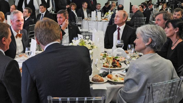 Michael Flynn (centre left) is seated next to Russian President Vladimir Putin at an event celebrating RT, the  government-backed Russian TV station.