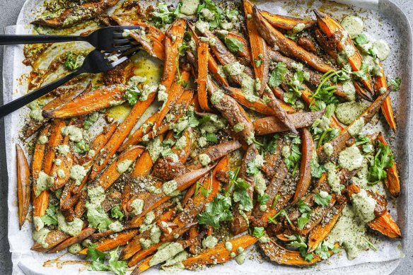 Sweet potato fries loaded with green tahini, harissa and zaatar salt.