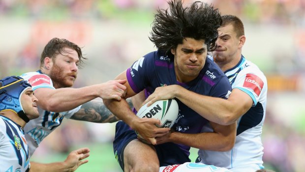 Evasive action: Tohu Harris of the Storm under pressure from all angles during the recent clash with the Titans at AAMI Park.