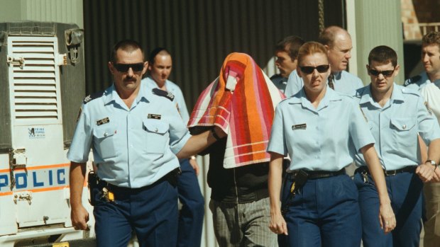 Stephen James Boney is led by police to Moree Local Court after being charged with rape in April 2000.