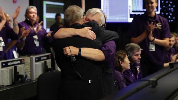 Cassini project manager Earl Maize and flight director Julie Webster hug in mission control at NASA's Jet Propulsion Laboratory in Pasadena, California after Cassini disintegrated in the skies above Saturn on Friday.
