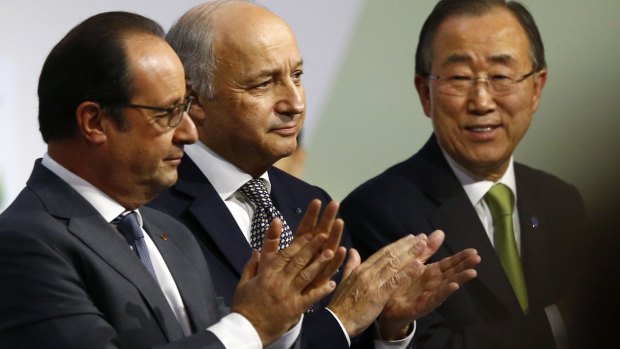French President Francois Hollande, left, French Foreign Minister Laurent Fabius and UN Secretary-General Ban Ki-moon at the Paris climate conference on Saturday.