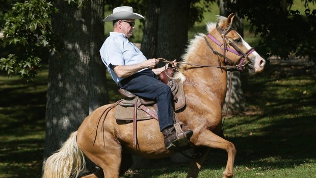 Former Alabama Chief Justice and US Senate candidate Roy Moore rides in on a horse to vote at an event during the Alabama Senate race in September. 