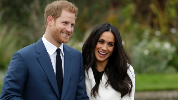 Prince Harry and his fiancee Meghan Markle pose for photographers during a photocall.