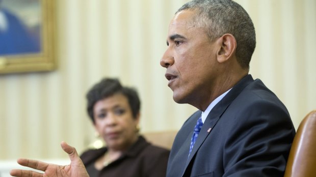 Attorney General Loretta Lynch listens as President Barack Obama speaks about gun control. 