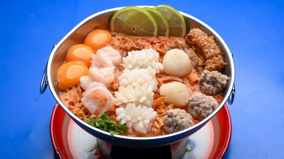 Go-to dish: Ultimate bowl with prawns, scallops, calamari, crispy pork, instant noodles and egg yolks.