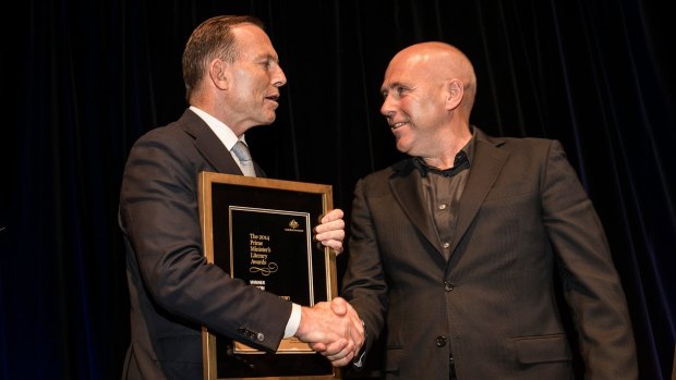 Prime Minister Tony Abbott presents Richard Flanagan with the 2014 award for best fiction.