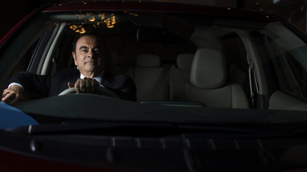Global Chairman of Nissan Carlos Ghosn with a new zero emissions Nissan electric car.