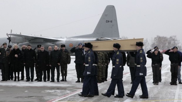 A coffin containing the remains of a victim of MH17 is carried on to a transport plane at Kharkiv airport in Ukraine on Friday en route to the  Netherlands.