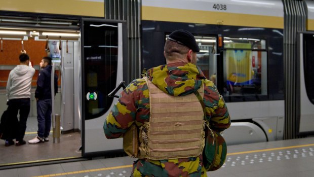 An armed soldier stands guard on the platform of De Brouckere Metro Station in Brussels, Belgium. 