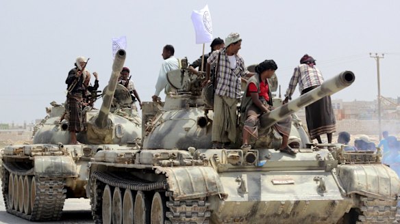 Tribesmen stand on tanks they took from army bases in Shihr city in Yemen's eastern Hadramawt province on Saturday.