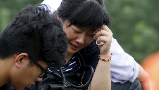 Hope fading: A relative of a passenger of the sunken cruise ship cries near the Yangtze River.