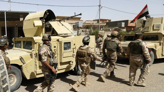 Iraqi security forces enter central Fallujah after fight against the Islamic State militants on Friday.