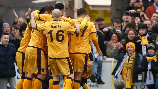 Sutton's players celebrate a goal during the FA Cup against Leeds United.