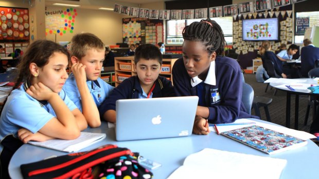 New-age learning: St Monica's Primary School students Nazanin Abdolllahihagh, Lachlan Roberts, Jackson Basha, and Salama Kunambi working together in a composite class and open study area.