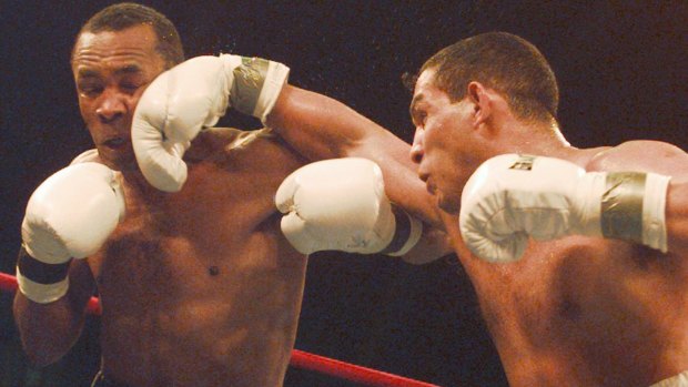 Hector Camacho (right) lands a punch on the chin of Sugar Ray Leonard in 1997.